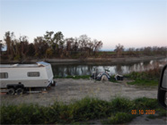 Levee of the Smith Canal showing debris and cutouts for steps and living area in the levee - Date of 03.11.2020 shows at the bottom of the photo