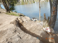 Levee of Smith Canal showing major levee cutouts and debris - Date of 03.11.2020 shows at the bottom of the photo